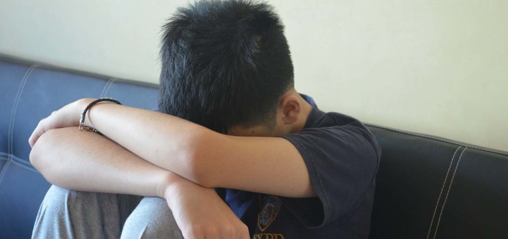 Boy with head down on arms